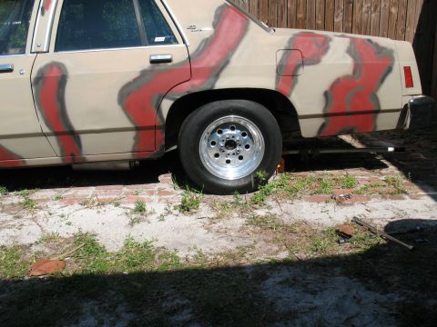 1985 Ford Crown Victoria LTD - Side view of a 1985 Ford Crown Victoria LTD with a unique tan and red camouflage-style paint scheme.
