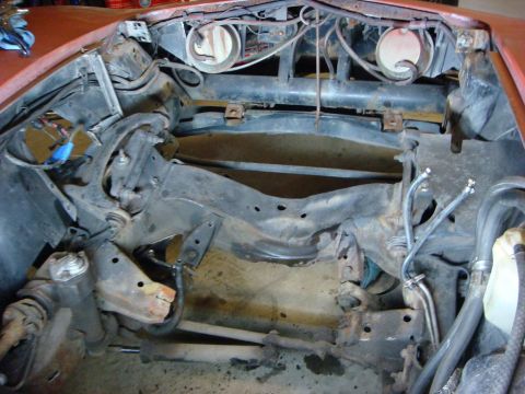 1975 Chevrolet Corvette - The engine bay of a 1975 Chevrolet Corvette shows suspension components and chassis structure.