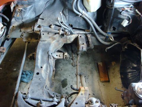 1975 Chevrolet Corvette - Front suspension and frame components of a car, likely undergoing repair or restoration.