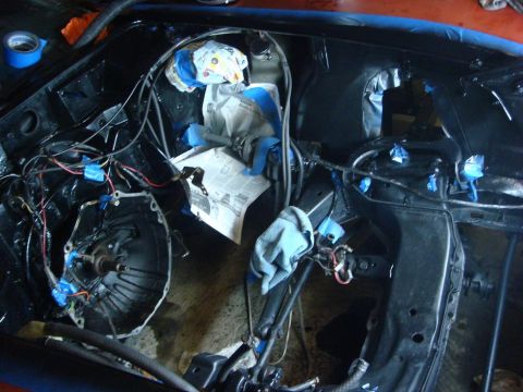 1975 Chevrolet Corvette - The engine bay is partially disassembled, with various components covered for protection during work.