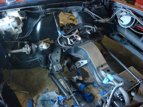 1975 Chevrolet Corvette - Close-up of a car's chassis and steering system during a repair or modification.