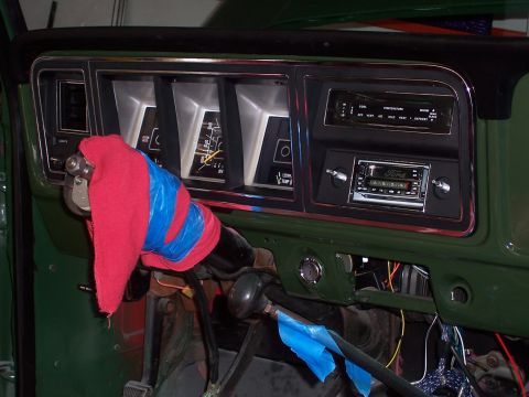 1978 Ford Bronco - Close-up of a vehicle's interior dashboard, showing the instrument cluster and radio area.