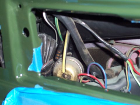 1978 Ford Bronco - Close-up view of a vehicle's interior wiring harness and electrical components, partially covered with blue tape.