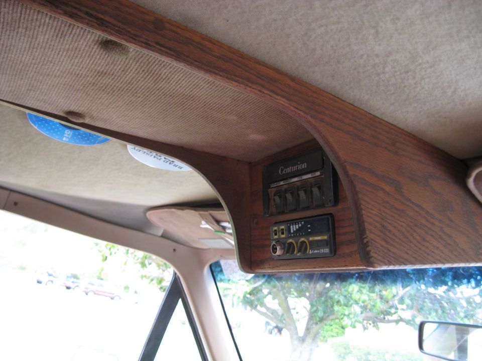 Overhead console in van with 'Centurion' label, four switches, and a CB radio