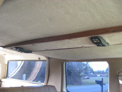 1995 Ford C-350 (Centurion Conversions) - The overhead console and side windows of a van reveal a view of the exterior surroundings outside.