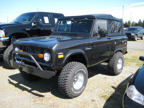 1980 Ford Bronco - A classic Ford Bronco is parked outdoors with other vehicles visible in the background.