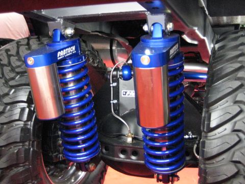1980 Ford Bronco - Custom rear suspension blue Fabtech Dirt Logic shocks and large off-road tires, likely for an off-road vehicle.