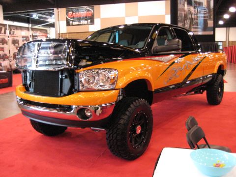 1980 Ford Bronco - Customized pickup truck on display at an indoor event with red carpeting.