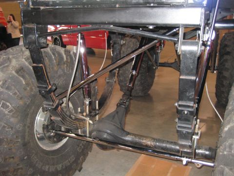 1980 Ford Bronco - The heavy-duty suspension and large tires suggest this vehicle is built for off-road use. A red vehicle is visible in the background.