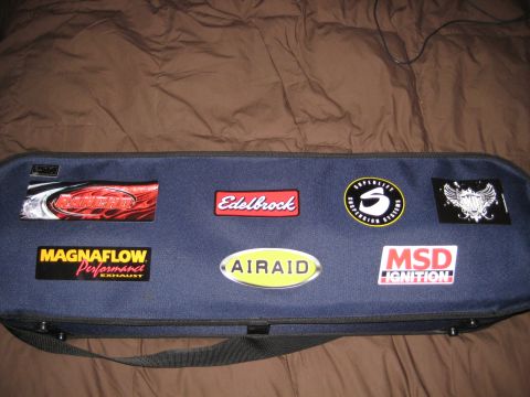 1980 Ford Bronco - Bag adorned with various performance automotive part brand stickers.