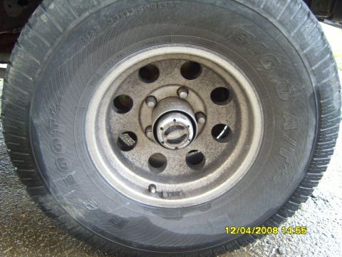 1989 Ford Bronco - A close-up view of a vehicle's wheel and tire, showing the tread pattern and rim details.