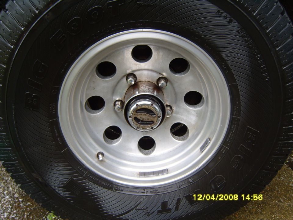 Close-up of a vehicle's wheel and tire with a chrome hubcap