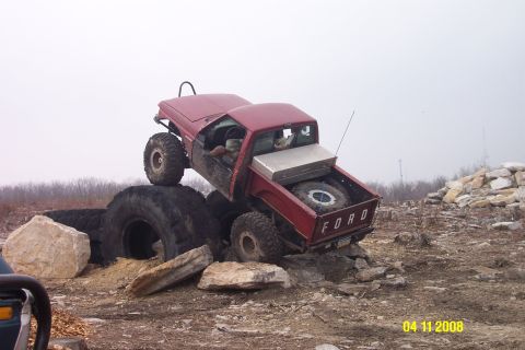 1992 Ford Bronco - Modified Ford pickup truck navigating a challenging off-road obstacle course.