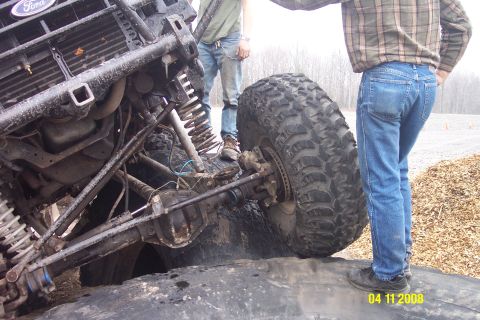 1992 Ford Bronco - This modified Ford Bronco has a custom roll cage and oversized tires, suggesting it is built for off-road use.