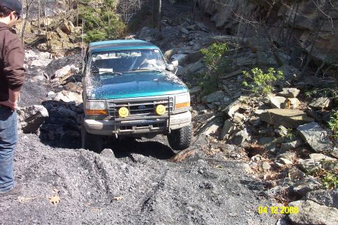 1992 Ford Bronco - Ford Bronco tackles a challenging off-road course on a sunny day.