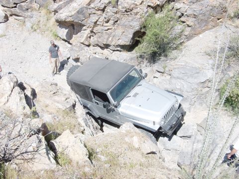 2004 Jeep Wrangler - A Jeep Wrangler Rubicon tackles a challenging rocky terrain, its off-road capabilities.