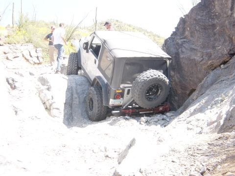 2004 Jeep Wrangler - A Jeep Wrangler navigates a challenging rocky trail, demonstrating its off-road capabilities.