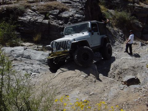 2004 Jeep Wrangler - Jeep Wrangler Rubicon tackling a challenging off-road course in a desert environment.
