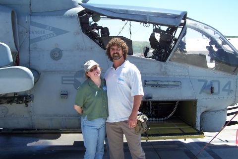 1990 Ford Bronco - A couple poses for a photo in front of a military helicopter.