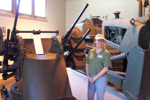 1990 Ford Bronco - A woman poses in front of a museum display that includes anti-aircraft guns and a tractor.