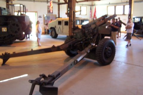 1990 Ford Bronco - Museum display an artillery piece alongside military vehicles.