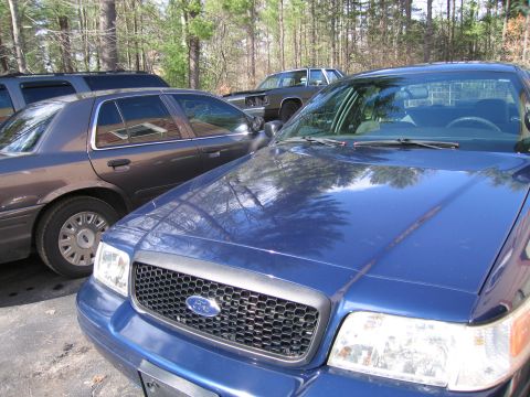 1991 Ford LTD Crown Victoria - A blue 1991 Ford Crown Victoria is parked in a driveway next to another car.