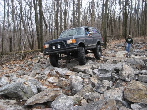 1991 Ford Bronco - This 1991 Ford Bronco tackles a challenging rocky path through a wooded area.