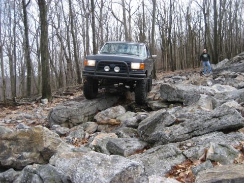 1991 Ford Bronco - A 1991 Ford Bronco tackles a challenging rocky trail during a meet and greet event.