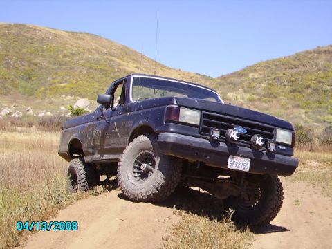 1990 Ford Bronco - This 1990 Ford Bronco is shown off-road, with a clear view of its grille and front end.