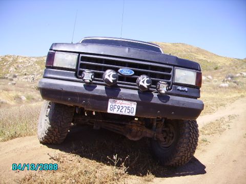 1990 Ford Bronco - 1990 Ford Bronco on a dirt road with KC lights and California plates.