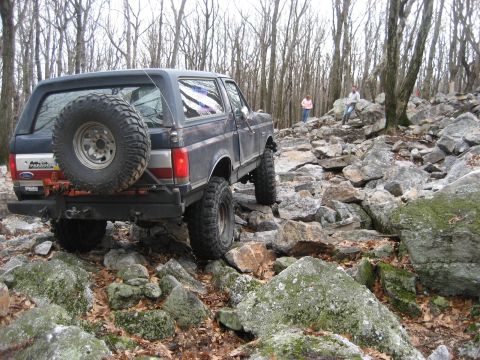 1991 Ford Bronco - Ford Bronco tackling a challenging rocky off-road course.