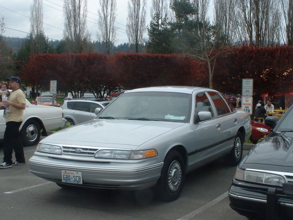 Silver sedan parked in a lot. License plate 680-SCB