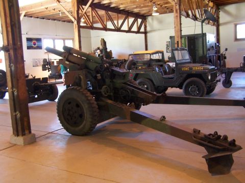 1990 Ford Bronco - Museum display features a large artillery piece and a USMC jeep.