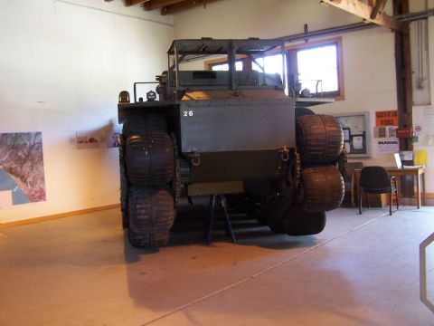 1990 Ford Bronco - This unusual vehicle, marked with the number 26, is displayed indoors with informational posters on the wall.