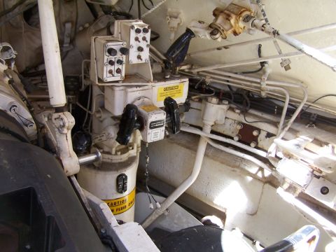 1990 Ford Bronco - Close-up of intricate controls and plumbing within a vehicle's interior.