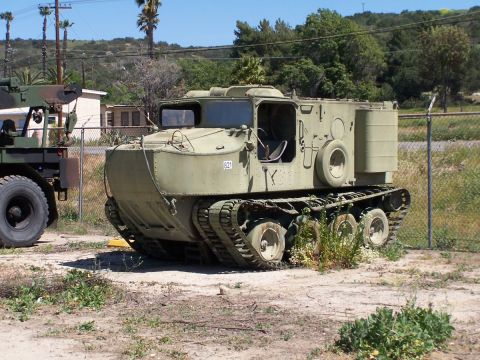 1990 Ford Bronco - This tracked vehicle, marked with the number 621, is parked next to another military vehicle.