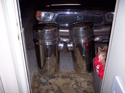 1981 Kenworth W900A - Two large chrome air cleaners are shown in front of a Mercury Mountaineer.