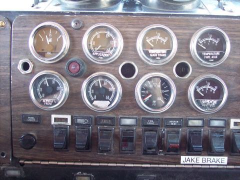 1981 Kenworth W900A - Close-up of a truck's dashboard, showing various gauges and control switches.