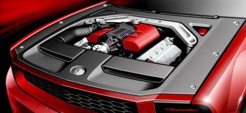 2005 Ford Mustang - Close-up view of a supercharged engine in a red vehicle's engine bay.