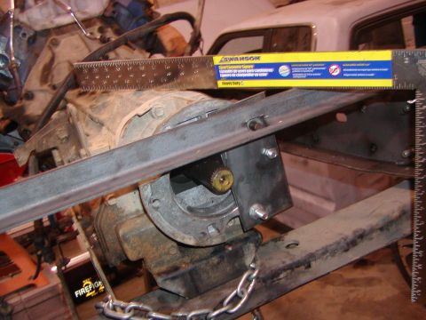 1991 Ford Bronco - A close-up view of a drivetrain component, possibly a transmission or transfer case, with a ruler for scale.