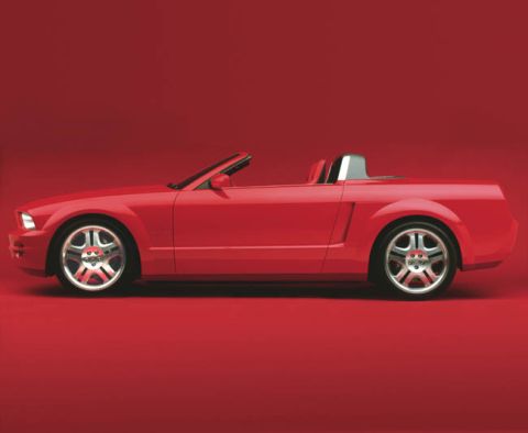 2005 Ford Mustang - Side profile of a red 2005 Ford Mustang convertible against a red background.