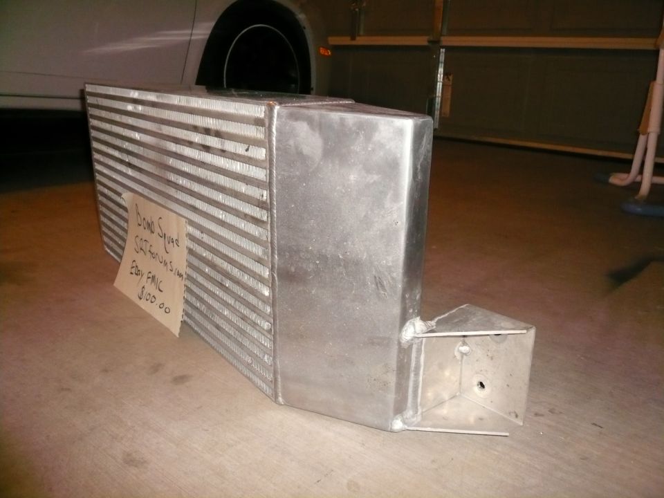 Aluminum intercooler with handwritten tag: "Bomb Squad SRT Forums.com Ebay FMIC $100.00"