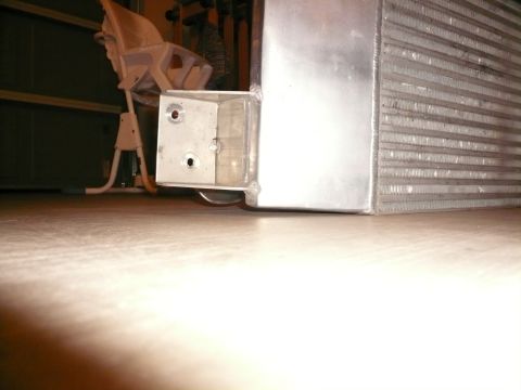 1996 Ford Probe - This is a close-up view of an intercooler, a component used to cool engine air. A baby high chair is visible in the background.
