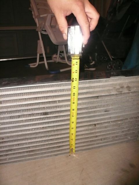 1996 Ford Probe - A tape measure is held against a radiator, indicating its dimensions.