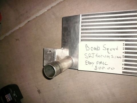 1996 Ford Probe - A close-up view of an intercooler with handwritten notes on a tag attached to its fins.