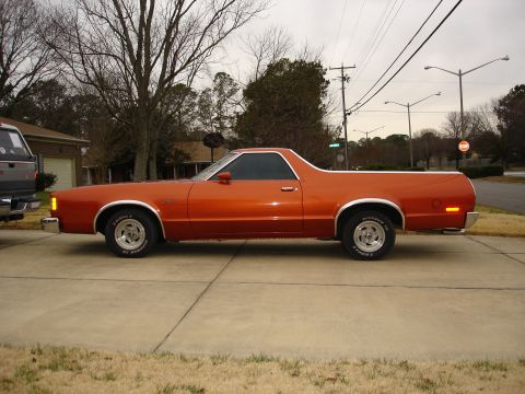 1979 Ford Ranchero - This 1979 Ford Ranchero is seen from the side, parked on a concrete driveway with a gray pickup truck to its left.