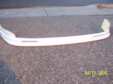 1994 Ford Probe - Aftermarket front bumper cover shown outdoors on asphalt. Date stamp reads 04/13/2008.