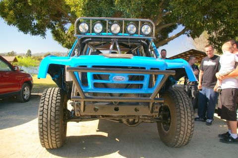 1986 Ford Bronco - This modified 1986 Ford Bronco features a prominent roll cage and a roof-mounted light bar, ready for off-road adventures.