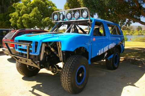 1986 Ford Bronco - Modified 1986 Ford Bronco with "Black Market Offroad" graphics and extensive roll cage.
