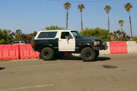 1986 Ford Bronco - This Ford Bronco, likely from the early to mid-1990s, is parked next to temporary construction barriers.